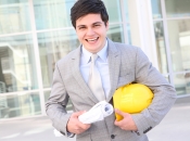 Public Works man in a suit with a hardhat and blueprints